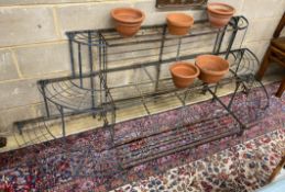A Victorian style iron 'D' shaped three tier pot stand, width 220cm, depth 60cm, height 73cm