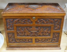 A Victorian carved walnut stationery case with Bramah lock, 42cm wide