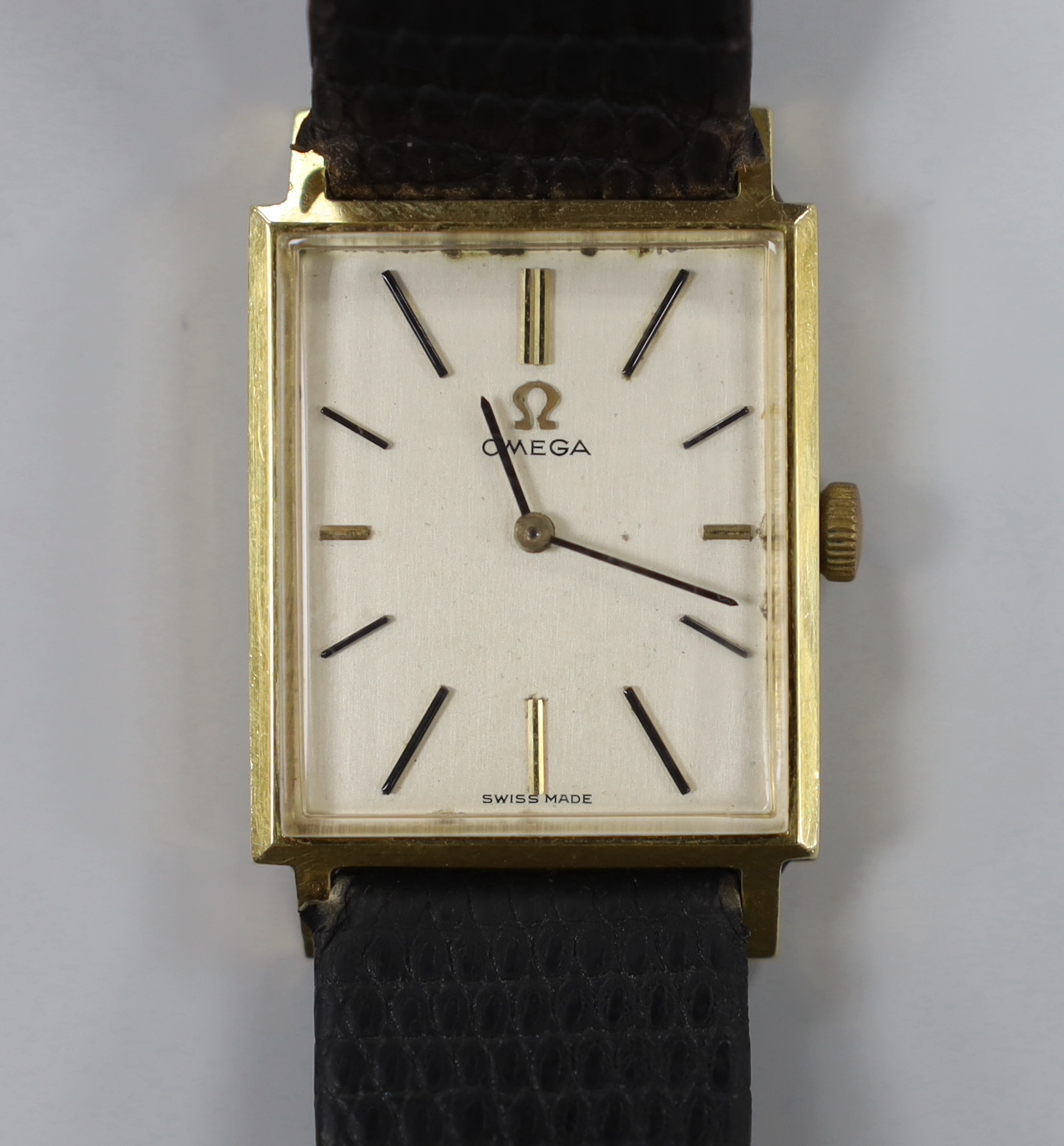 A gentleman's 18k Omega manual wind rectangular dress wrist watch, on associated leather strap, case