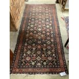 An antique Hamadan blue ground rug 270cm x 120cm