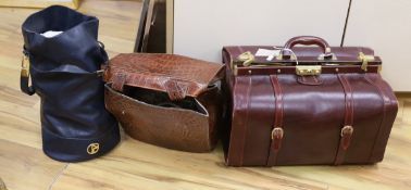 An oxblood leather Gladstone bag, a faux crocodile bag and one other