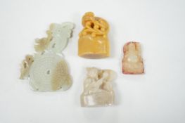 A collection of Chinese jade and soapstone carvings, largest a carved panel 11cm long