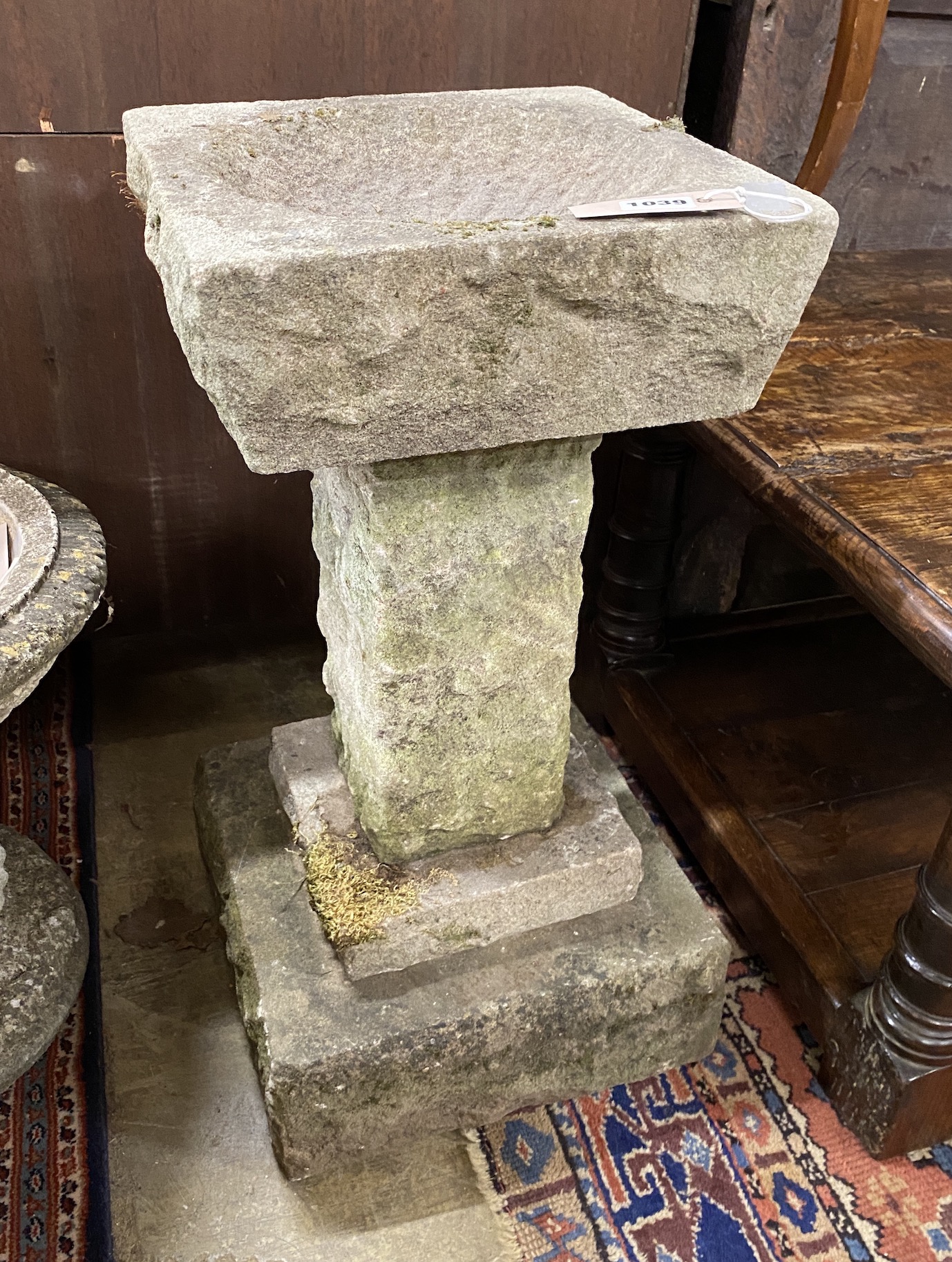 A reconstituted stone granite effect bird bath, height 58cm