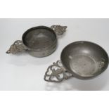 An 18th century French pewter two handled ecuelle, lacking cover, and one other, largest 27cm