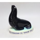 A Carltonware Guinness ‘seal’ lamp stem “Guinness is good for you”, 18cm tall