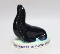 A Carltonware Guinness ‘seal’ lamp stem “Guinness is good for you”, 18cm tall