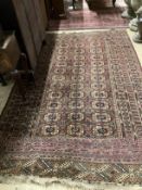 A Bokhara burgundy ground rug, 260 x 160cm