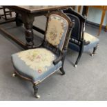 A pair of late Victorian ebonised and amboyna salon chairs with petit point upholstery, width