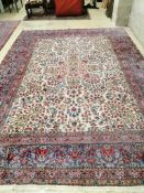 A Persian Kirman ivory ground carpet, 380 x 272cm