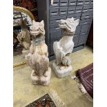 A pair of reconstituted stone dog and shield garden ornaments with cast metal collars, height 81cm