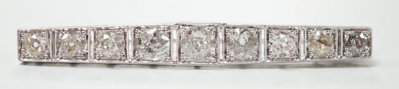 A 1920's/1930's white metal and graduated nine stone diamond set bar brooch, 48mm, gross weight 4.
