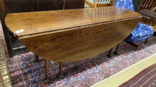 A reproduction 18th century style oak drop leaf wake table, length 196cm, width 153cm extended,