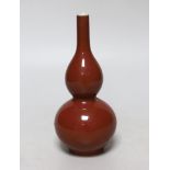A small Chinese sang de boeuf glazed double gourd vase, 17cm high