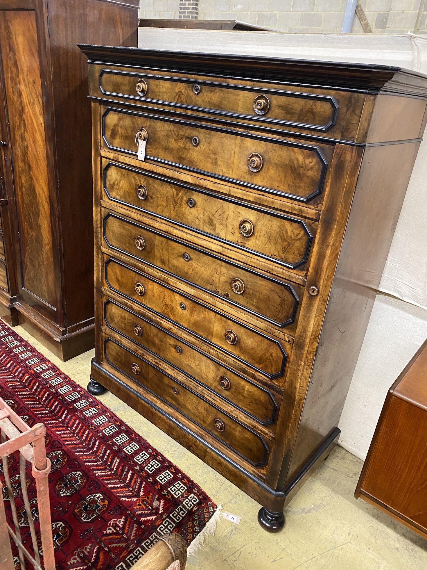 A 19th century French walnut seven drawer chest, with side locking bar, width 127cm, depth 57cm,