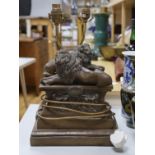 A pair of Thomas Blakemore recumbent lion table lamps, 43cm tall