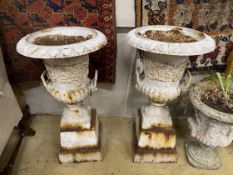 A pair of painted cast iron campana garden urns on stepped square plinths, diameter 46cm, height