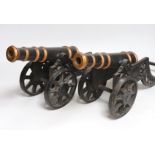 A pair of cast iron models of cannons, 48cm long