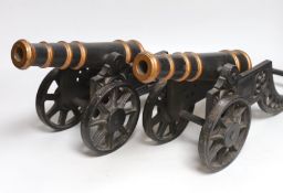 A pair of cast iron models of cannons, 48cm long