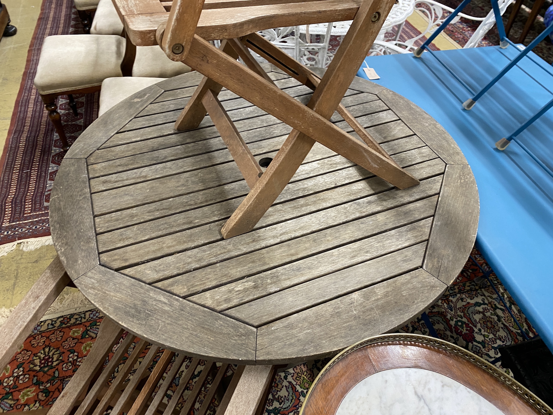 A circular weathered teak folding garden table, diameter 100cm, height 73cm and two elbow chairs - Image 2 of 3