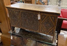 A 17th century style “Sussex” oak six plank coffer with a carved front, width 85cm, depth 36cm,