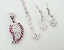 A modern white metal ruby and diamond cluster set drop pendant, modelled as a pear, overall 26mm,