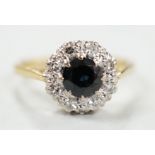 A 1960's 18ct gold, sapphire and diamond set circular cluster ring, size N, gross weight 3.7 grams.
