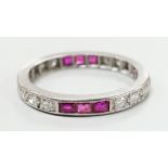 A white metal, ruby and diamond set full eternity ring, size L/M, gross weight 3.1 grams.