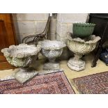 A pair of reconstituted stone acanthus garden planters, a similar larger planter and a cast iron