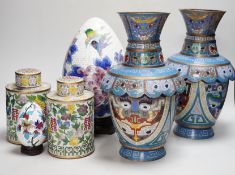A pair of Chinese cloisonné enamel vases, a pair of canisters and covers, a large egg on stand and a