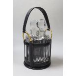 An Hermes black leather decanter set, fitted with two Baccarat glass decanters