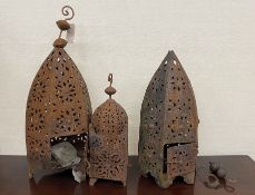 Three Moorish style weathered metal garden lanterns, largest height 60cm