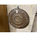A Newlyn School style circular embossed copper wall plaque, diameter 60cm