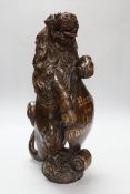 A carved oak lion holding a shield with inscription, possibly 17th/18th century with Victorian