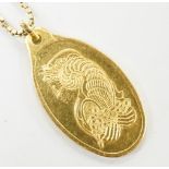 A Suisse 10g yellow metal 'Fine Gold 999.9' oval ingot pendant, on a 9ct gold chain, 3.6 grams.