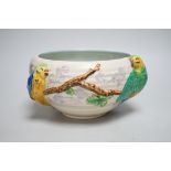 A late Clarice Cliff bowl with perched parrot decoration, 12cm tall