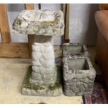 A pebble effect reconstituted stone bird bath, height 67cm together with two similar smaller