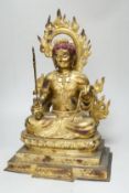 A large Sino-Tibetan gilt bronze figure of Fudo Myob (Acala), 44cm high