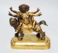 A Sino-Tibetan gilt bronze group of a deity on lionback, 15cm wide