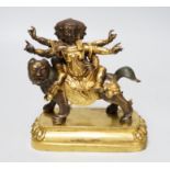 A Sino-Tibetan gilt bronze group of a deity on lionback, 15cm wide