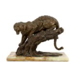 William Timym (British, 1902-1990). A bronze model of a jaguar crouched upon a tree trunk, signed in