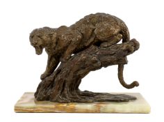 William Timym (British, 1902-1990). A bronze model of a jaguar crouched upon a tree trunk, signed in