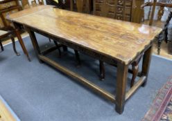 A late 17th / early 18th century elm two plank top refectory table (re-cleated), length 186cm, depth