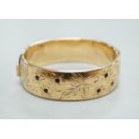 A 1960's 9ct gold hinged bangle, by Smith & Pepper, 30.4 grams and a rolled gold bangle.