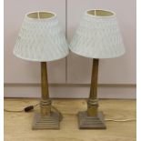 A pair of plated Corinthian column table lamps with green silk shades, 49.5cm tall