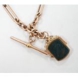 An Edwardian 9ct gold albert, hung with a bloodstone set swivelling fob, 38cm, gross weight 51.1