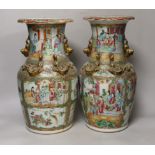 A pair of Chinese Canton decorated famille rose enamelled vases, 36cm high