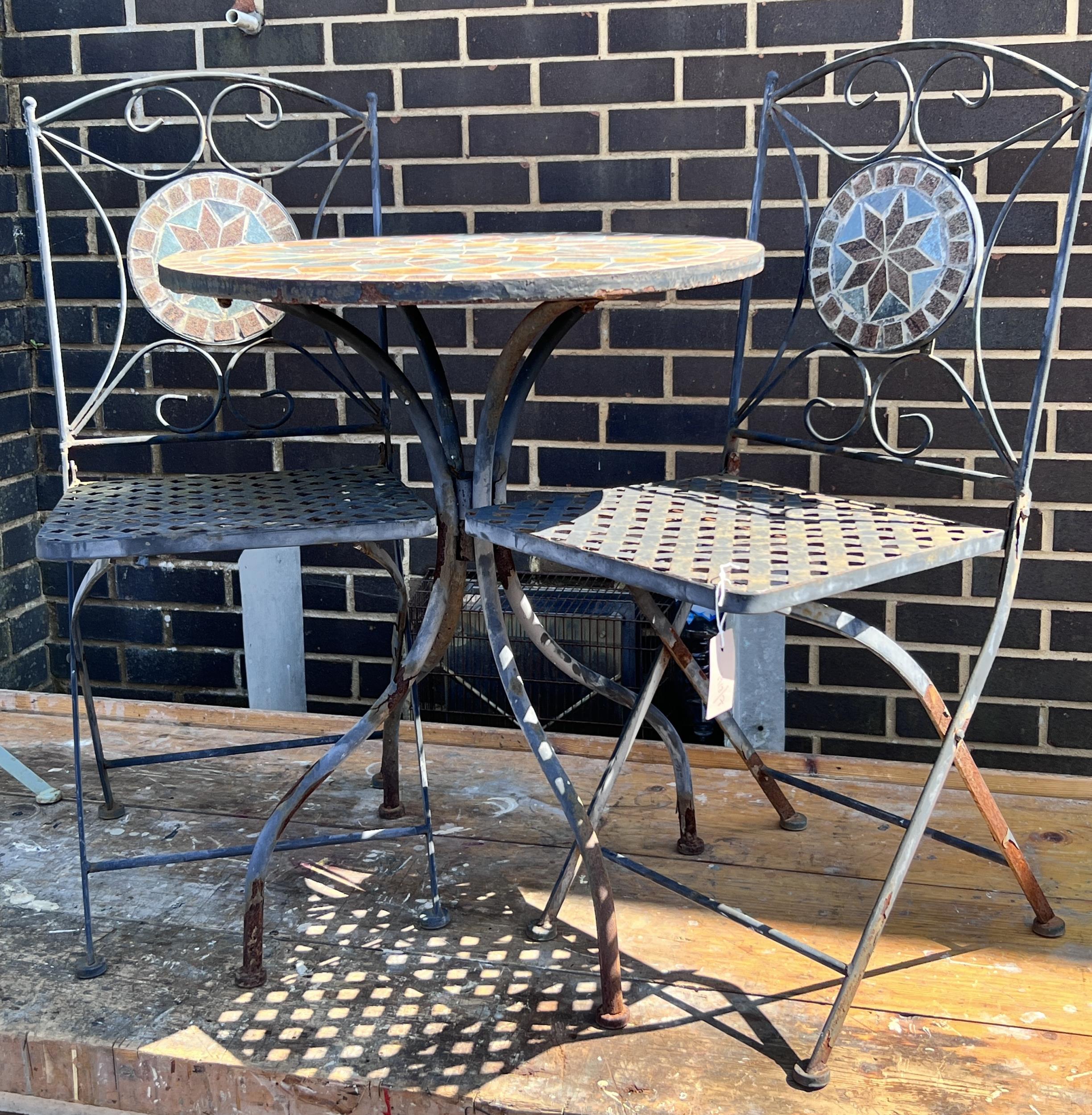 A circular mosaic topped garden table, diameter 60cm, height 73cm, and a pair of matching folding