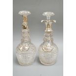 A near pair of George V silver mounted cut glass decanters and stoppers, by Hukin & Heath,