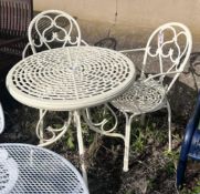 A circular aluminium garden table, diameter 74cm, height 73cm, and two elbow chairs