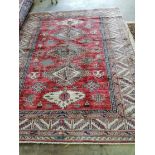 A Caucasian style red ground rug, 236 x 184cm